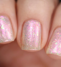 nail polish by crystal knockout, angel aura shock, sheer white with pink glow and iridescent flakes