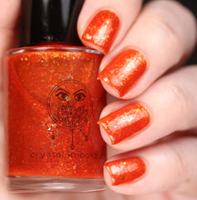 nail polish by crystal knockout, carnelian meld, red orange jelly with gold flakes and shimmer