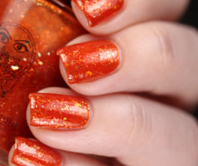 nail polish by crystal knockout, carnelian meld, red orange jelly with gold flakes and shimmer