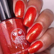 nail polish by crystal knockout, carnelian meld, red orange jelly with gold flakes and shimmer