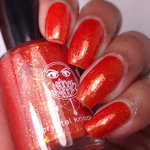 nail polish by crystal knockout, carnelian meld, red orange jelly with gold flakes and shimmer