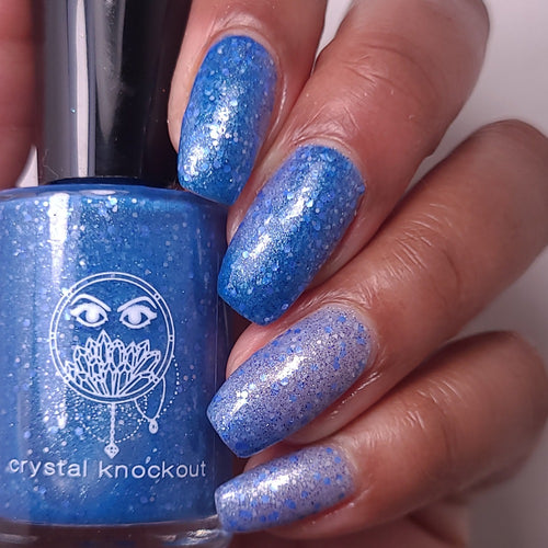 nail polish by crystal knockout, aventurine hit, a dark blue to light blue thermal with matte blue and white glitter